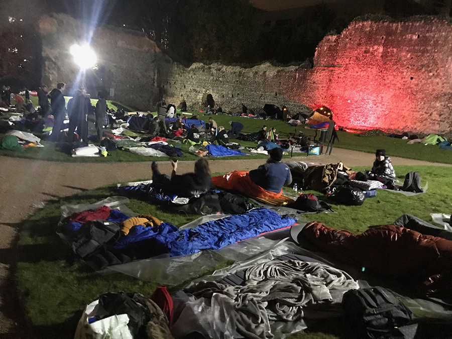 people laying in on grass at night to raise money