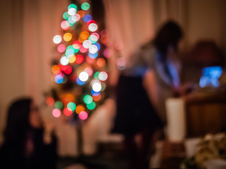 support - blurred Christmas tree and girl
