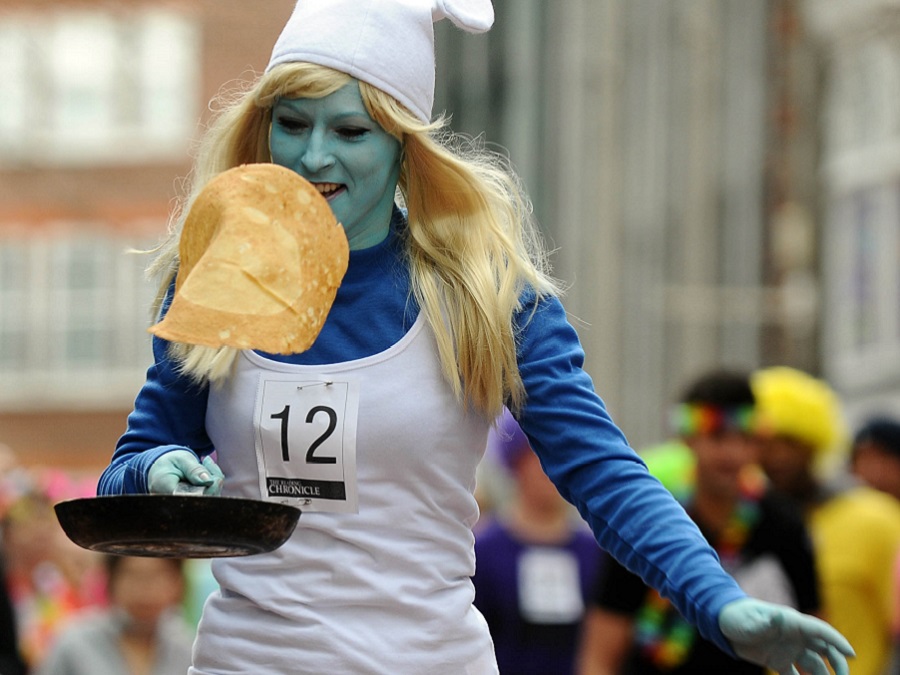 girl in smurf outfit flipping pancake