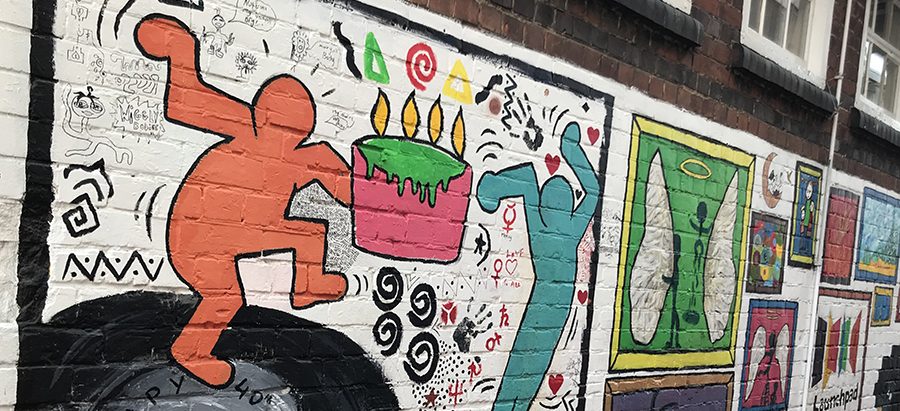 Photo of the graffiti wall, painted on the office wall, where the staff and volunteers work.