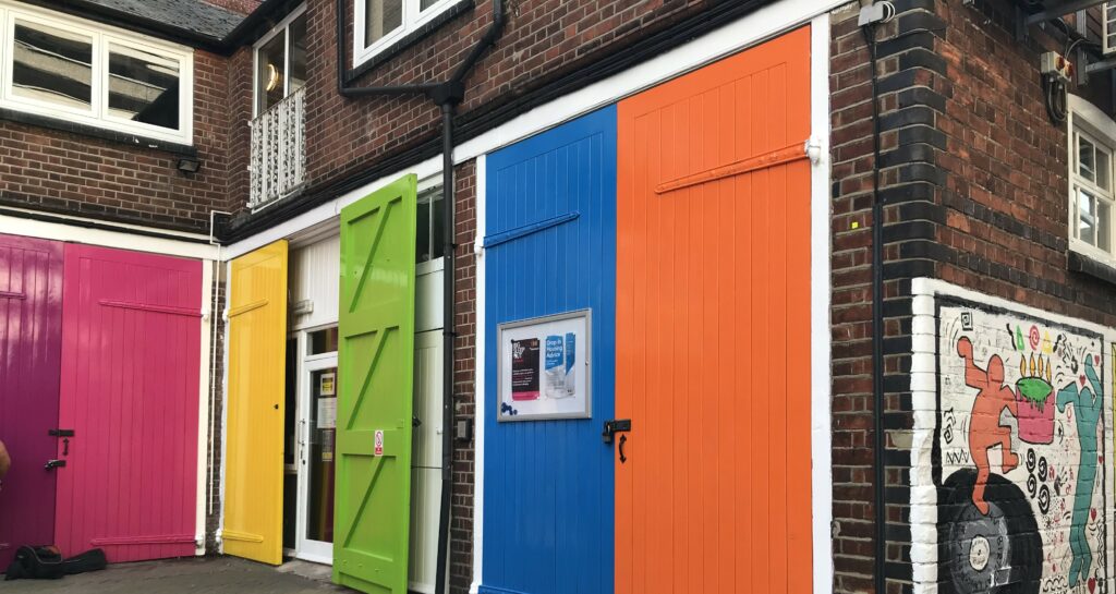 The colourful stable doors at Launchpad's office in Reading town centre, there is a purple, pink, yellow, light green, mid blue and orange door.