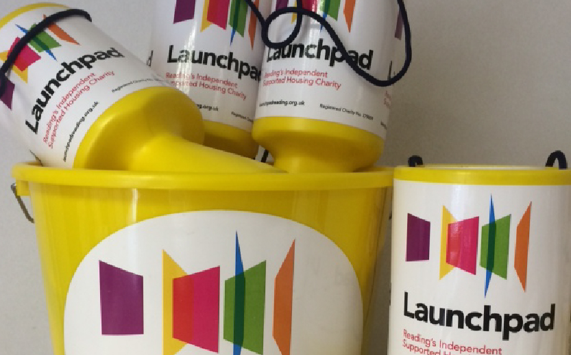 Launchpad collection pots and bucket in a pile. They have colourful Launchpad logo stickers on them