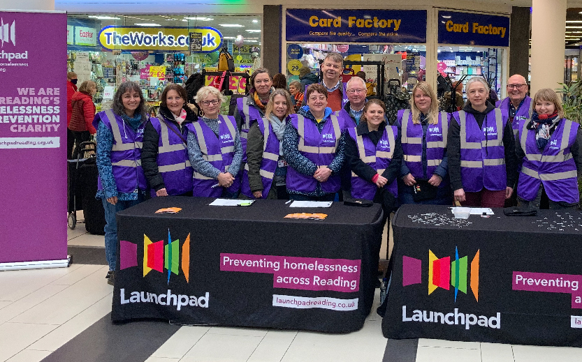 A large group of Launchpad volunteers, they're all wearing purple Launchpad bibs, they're ready to help out at our pancake race