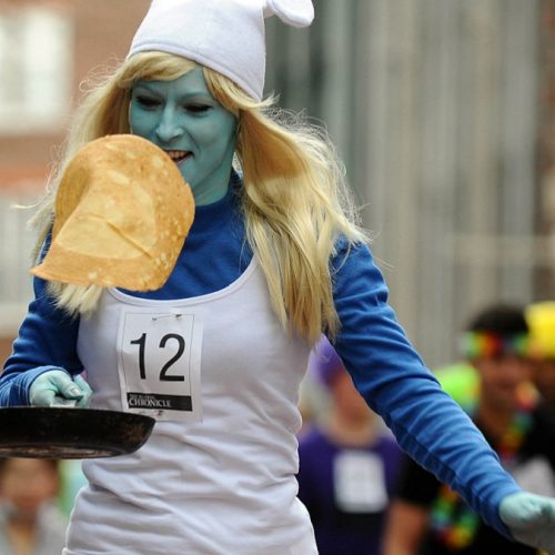 girl in smurf outfit flipping pancake